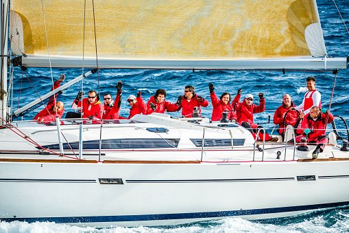 Sailing crew on sailboat during regatta